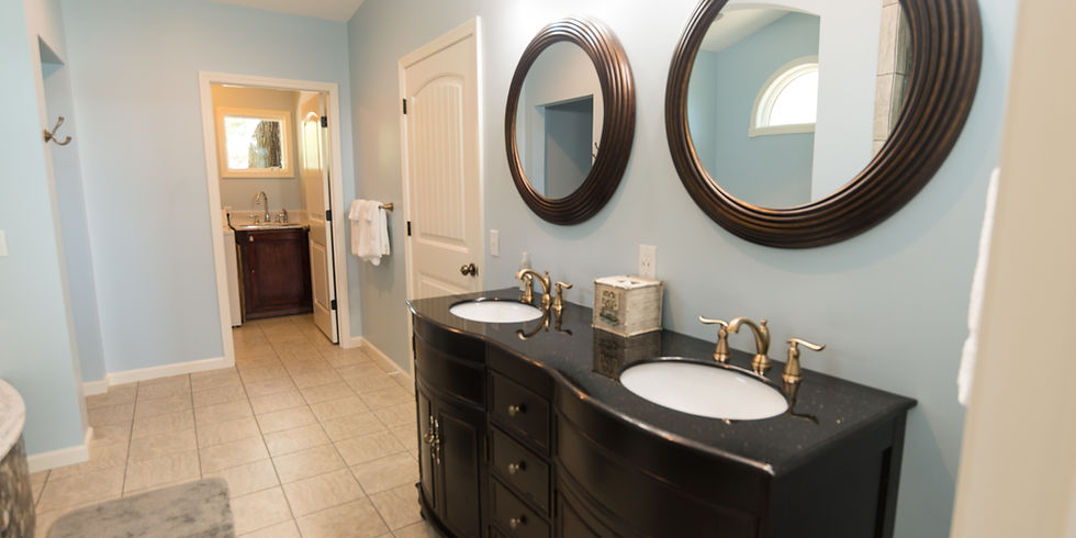 Luxury master bathroom with double vanity and granite countertops at Guntersville Getaway vacation rental